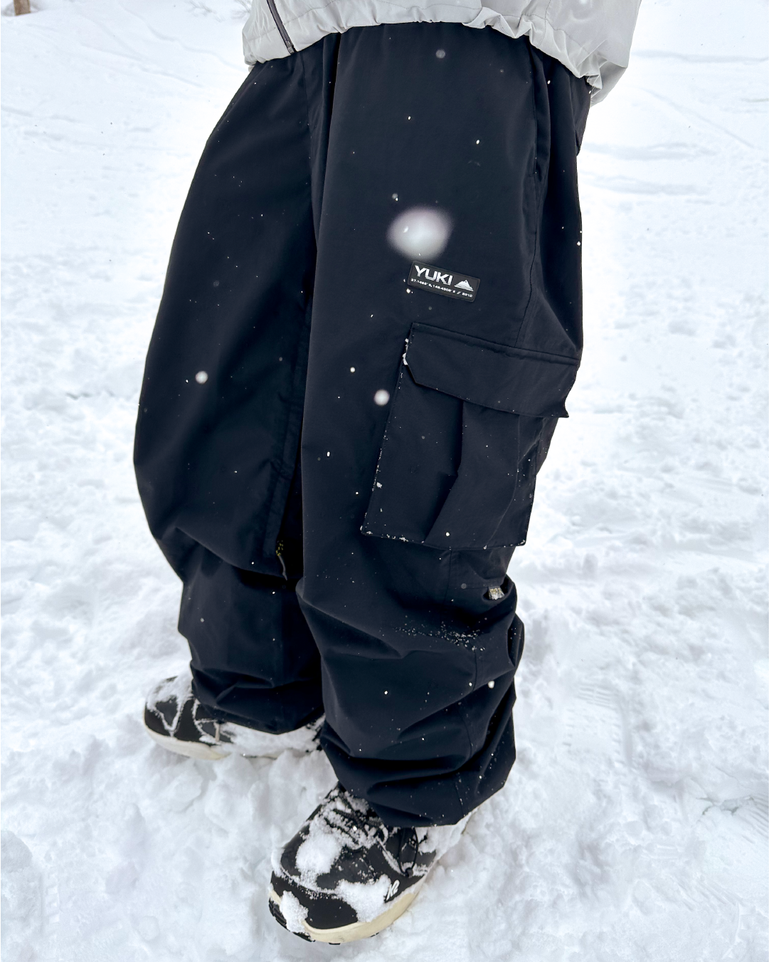 black snow pants being worn in the snow