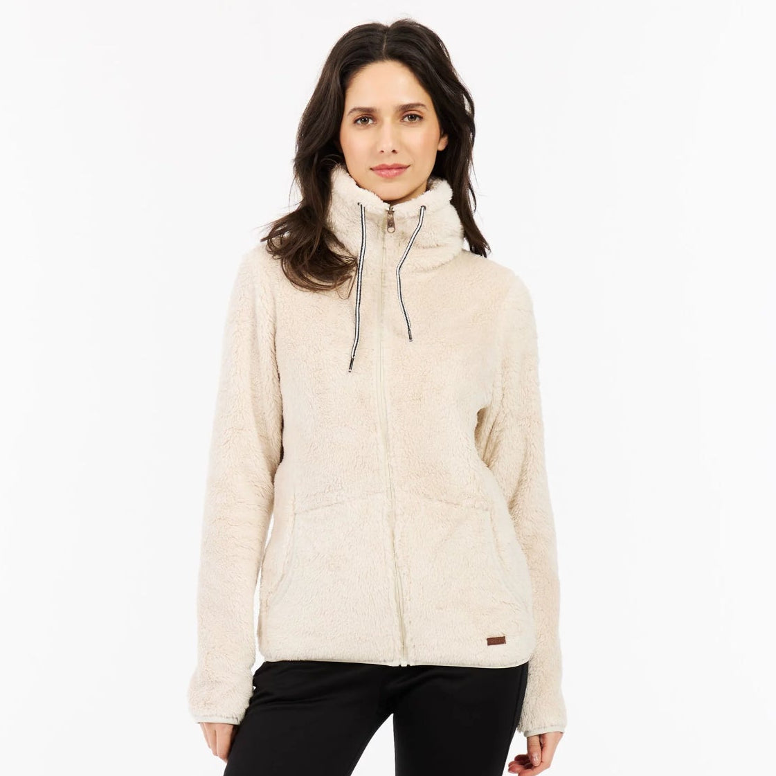 Woman wearing a beige jacket, black pants, and yellow boots on a white background