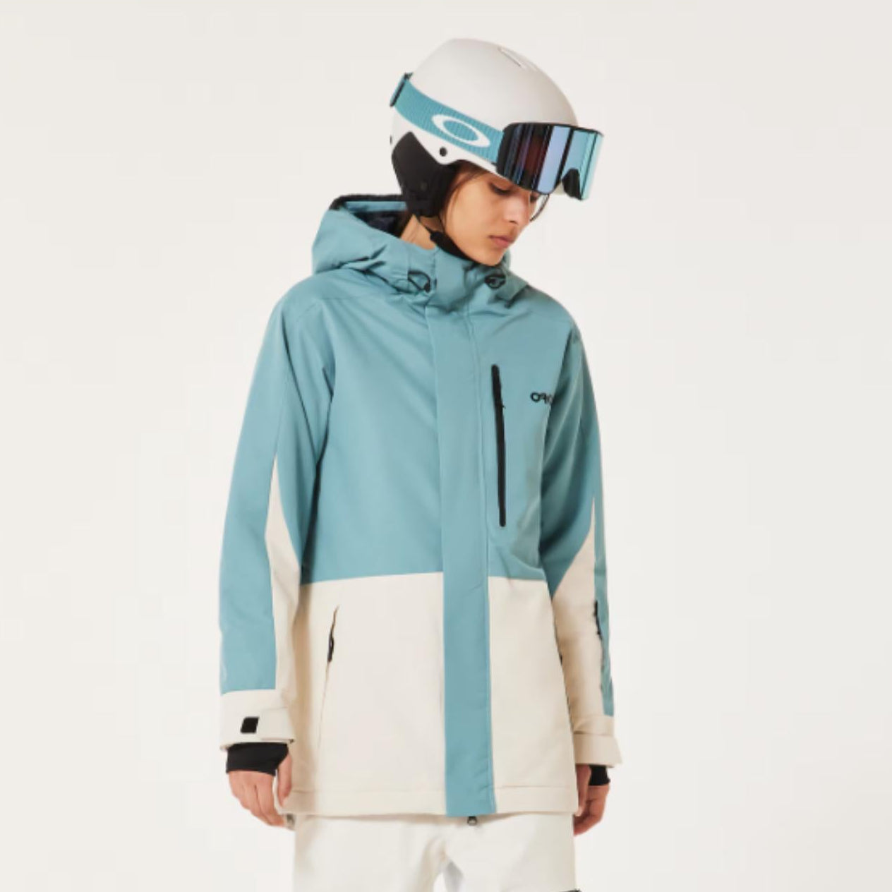 Person wearing a blue and white snow jacket with matching pants on a white background